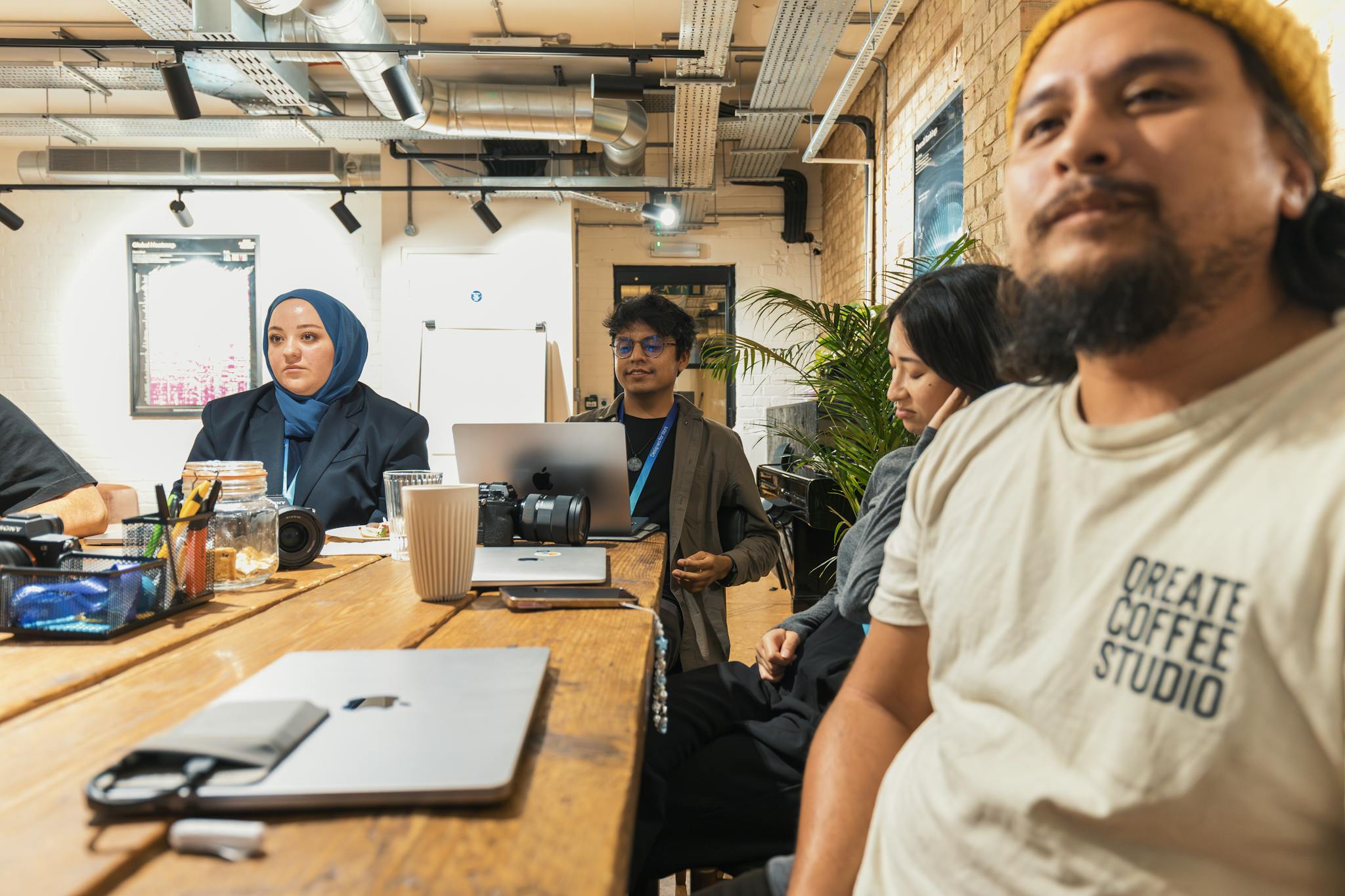 A diverse group of people in a brainstorming session at a modern office.